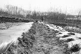 A monochrome image of a man diligently working on a farm, showcasing the essence of agricultural labor.
