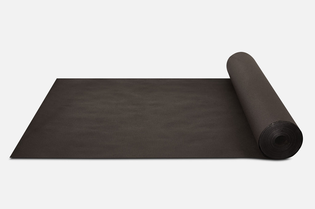 Biodegradable Paper Mulch rolled up on a white surface