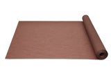 Heavyweight Paper Natural  Biodegradable Mulch rolled up on a white surface