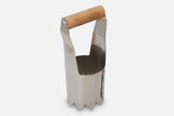 A handheld sharp metal tool for cutting holes in mulch or landscaping materials